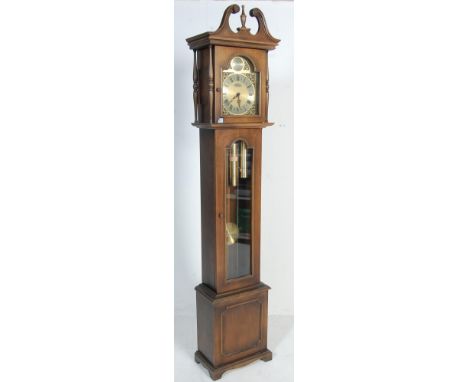 An antique style Regency revival Bluart longcase / grandfather clock having a finial top set within swan neck pediments atop 