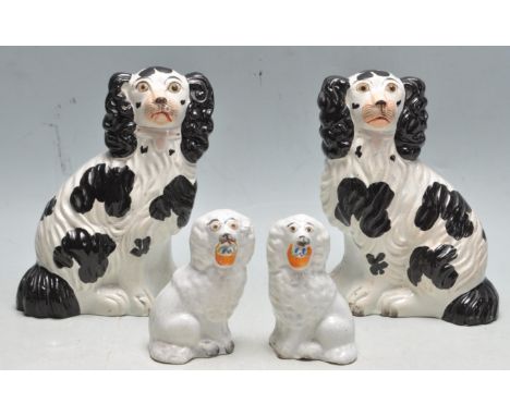 Two pairs of antique Edwardian &nbsp;Staffordshire ceramic comforter spaniel dogs to include a large black and white example 