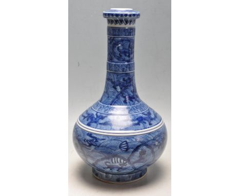 A 19th Century Chinese antique Kangxi mark porcelain ' Garlic Mouth ' vase having hand painted blue and white decoration depi