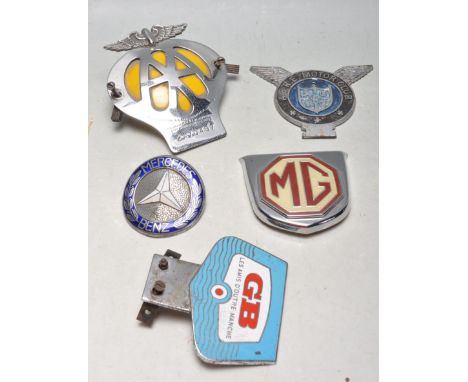 A collection of five vintage retro 20th century transport and automobile related car badges to include an AA ( automobile Ass