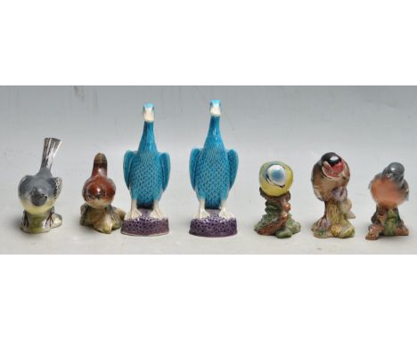 A pair of early 20th century Chinese ceramic porcelain blue / turquoise duck figurines. The duck raised on a purple natural p