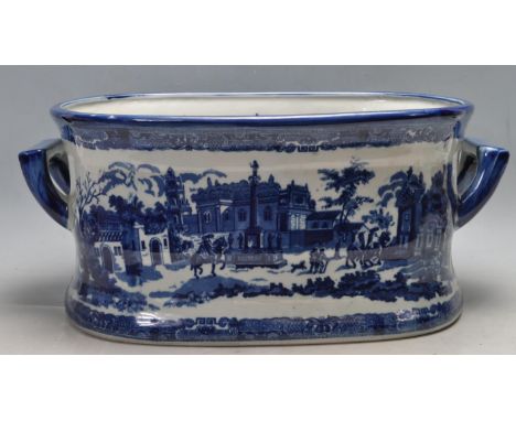 An antique Victorian ceramic blue and white foot bath of oval form with carry handles to the side. The foot bath having a fin