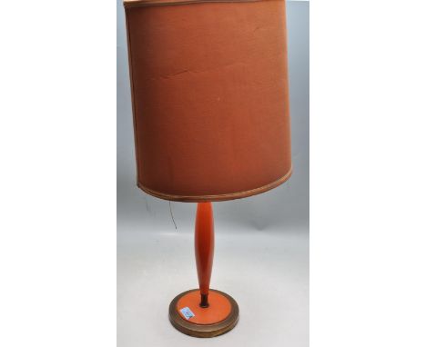 A retro vintage 1960s desk / table lamp having a shaped orange central column support raised on a stepped circular brass base