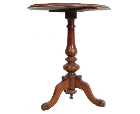 A 19th century Victorian mahogany tripod wine table. Raised on splayed legs with turned column to centre and a circular chamf