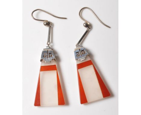 A pair of 1930's Art Deco white gold and hard stone stone panel earrings of triangular form having geometric red and white st