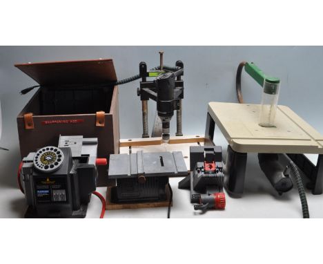 A collection of contemporary precision model making equipment tools including a table drill, The Chopper, table jigsaw, Plasp