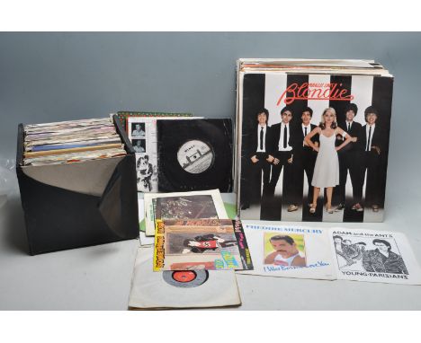 A collection of vintage 20th century 12” vinyl records and 45’s rpm vinyl records to include U.B.40, Freddie Mercury, Adam An