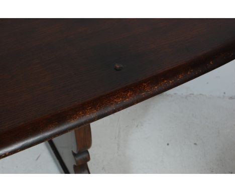 A vintage 20th Century Ercol Old Colonial oak dark wood refectory dining table raised on Windsor supports united by a single 