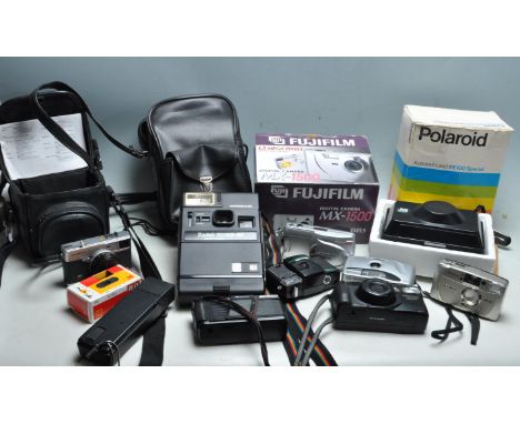 A collection of vintage cameras to include a boxed Polaroid box camera, Kodak EK160-EF, Olympus C-900 zoom, Fujifilm MX 1500,