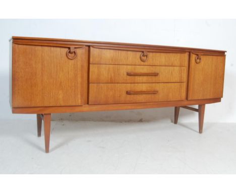 A retro vintage 1970s Beautility teak wood sideboard credenza. The sideboard having a central bank of three drawers flanked b
