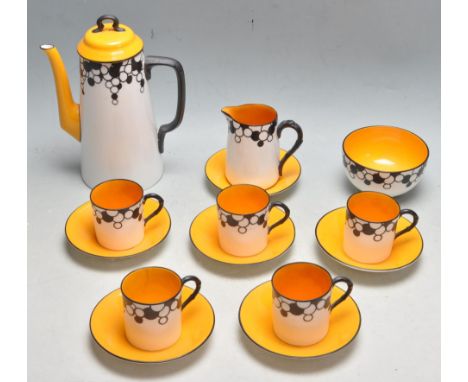 A 1920’s Royal Worcester Art Deco pattern coffee service comprising of a coffee pot, creamer jug,m sugar bowl, five cups and 