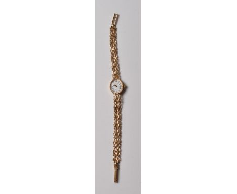 A vintage ladies 9ct gold Sovereign Quartz wrist watch having an oval face with roman numerals to the chapter ring the bracel
