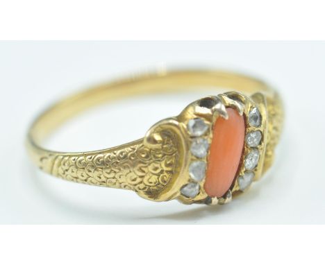 A 19th Century Victorian gold coral and diamond ring having a central coral panel flanked by two rows of diamond accent stone