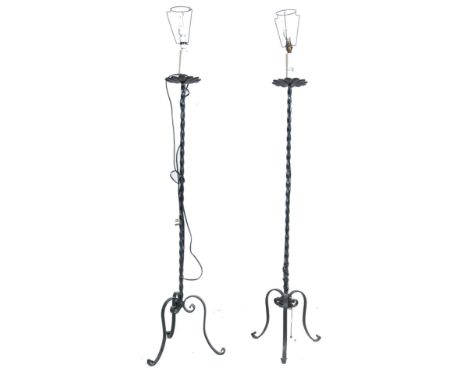 A pair of 20th century antique style French blacksmith floor standing scroll work wrought metal floor / standard lamps. Each 
