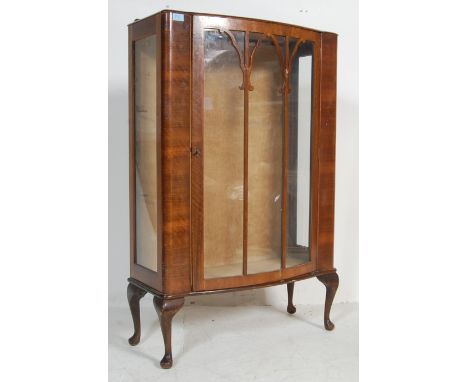 An vintage mid century walnut veneer china display bookcase cabinet vitrine having a glazed door with astragal glazing openin