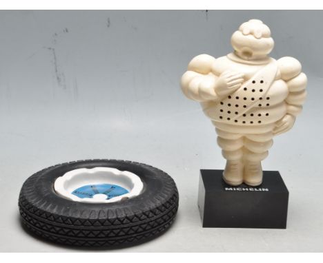 A vintage retro late 20th Century Michelin advertising radio in the form of the Michelin man on a black base marked (electric