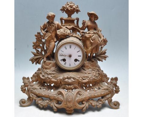 An early 20th century French garniture mantel clock having a white enamel clock face, roman numerals to the chapter ring flan