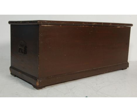 A vintage mid 20th century pine chest having a flared lid opening to reveal a spacious interior raised on a plinth base paint