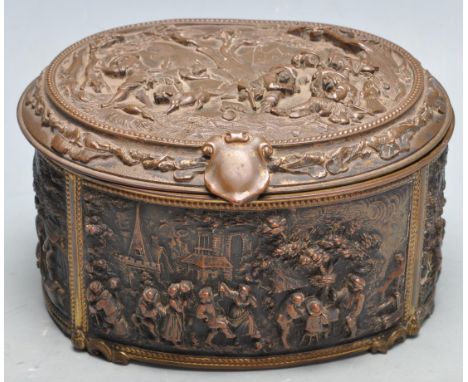 A late 19th Century French antique cast metal dressing table box of oval form having moulded relief decorated panels with pro