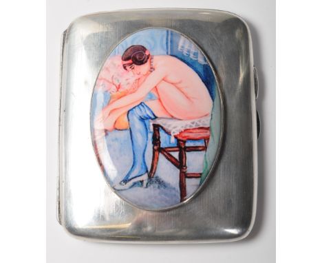 An antique early 20th century hallmarked sterling silver cigarette case having a engine turned body with a&nbsp; large polych