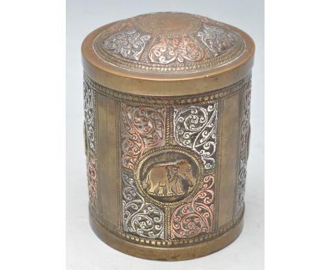 An antique 19th century fine brass, copper and silver tea caddy of cylindrical form having floral decoration with a repeating