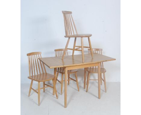 A vintage retro 20th century Ercol style beech and elm dining table and chairs. The table of a rectangular form with two drop