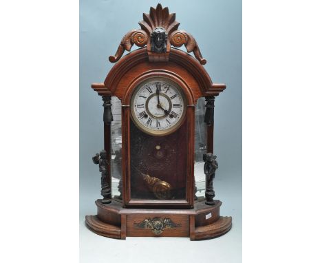 A late 19th century Victorian American mahogany wall clock by the Ansonia Clock company. The clock having having a brass and 