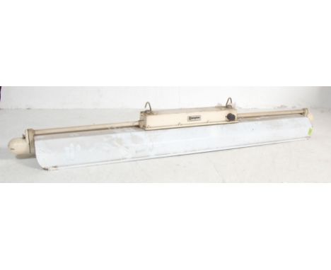 A large retro vintage 1960s industrial workshop light of rectangular long form by Crompton having a large white enamel light 