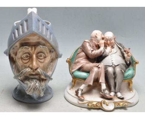 A vintage Italian Capodimonte ceramic figurine titled “ The Gossips “ depicting two gentlemen sitting on a bench by the Giuse