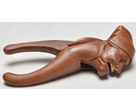 An antique late 19th century / early 20th century Swiss Alpine treen / novelty nutcracker, made by Rigi Kulm. The nutcracker 