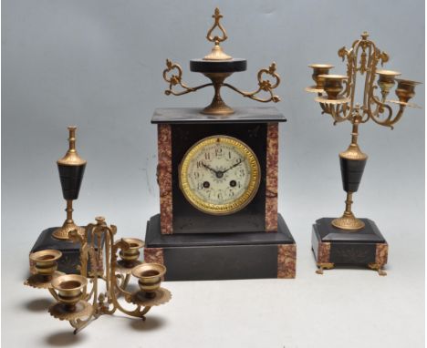 A French 19th century eight day black slate marble mantel clock garniture de cheminee. The set comprising of a black and red 