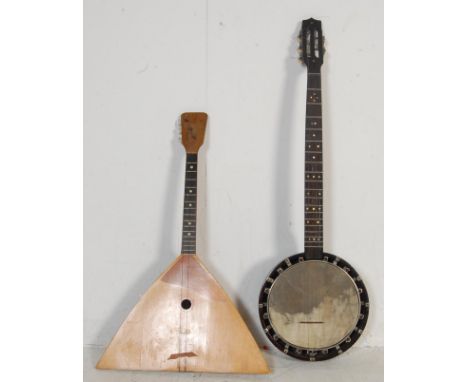 A vintage 20th century Russian balalaika having an angular shaped sound box with makers label applied within together with a 