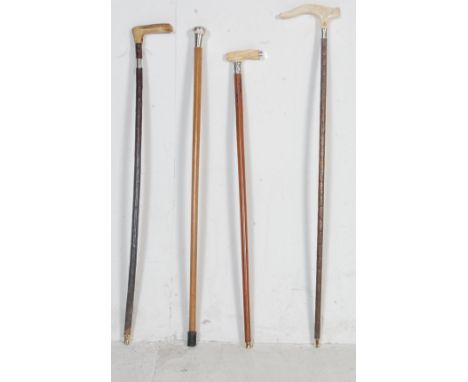 A collection of four antique Edwardian and later walking sticks comprising of a bone handled walking cane with chinese orient