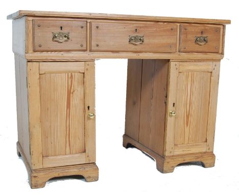 A Victorian 19th century pine twin pedestal office writing desk. Raised on plinths with cupboards to each having reeded field