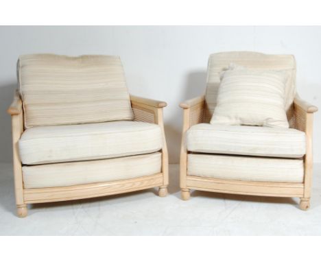 A pair of contemporary Ercol Windsor range armchairs / easy chair. The chairs with bergere caned armrests with upholstered se