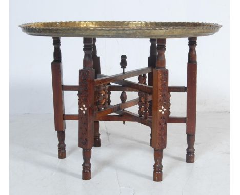 A vintage 20th Century Indian / Middle Eastern brass topped Binares occasional table having engraved and repousse patterned d