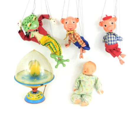 Bygone toys, including a tinplate spinning top, a frog puppet, two little pigs puppet, and a Marlon Creations sleeping baby d