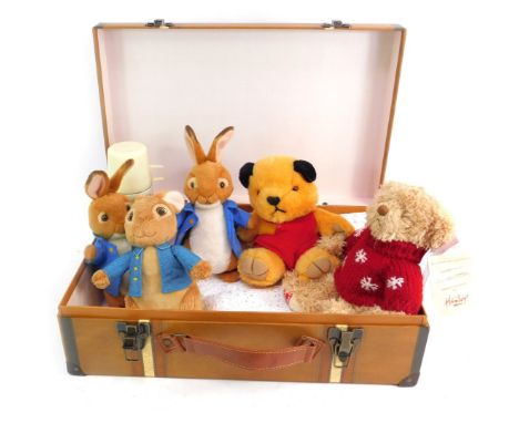 A toy trunk and contents, to include two TY Peter Rabbits, a Rainbow Designs Peter Rabbit, Sooty and a Hamleys Teddy bear.