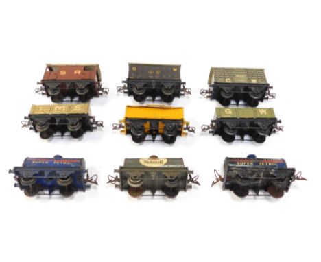 A group of tinplate O gauge rolling stock, including Portland cement wagon, Red wire Gliwo oil tanker, Mobil oil tanker, vent