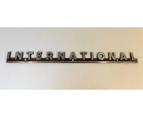 A chrome "International" Fire Engine maker plaque 21.75in wide x 2in high
