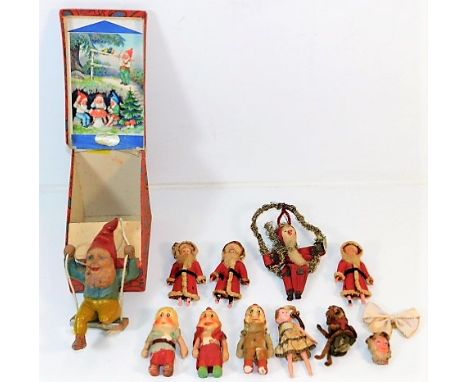 A boxed Heissner gnome on swing, loss to one end of leg twinned with three pottery dwarfs &amp; some vintage Christmas decora