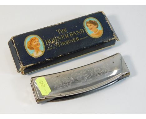 A vintage Hohner harmonica with box