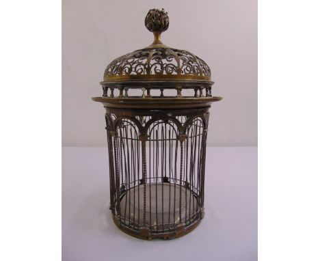 A Victorian cylindrical brass birdcage with scroll pierced arched top and bud finial