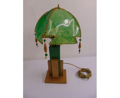 An Art Deco table lamp, green and gold painted geometric column with green shade on rectangular base