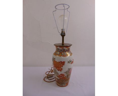 An oriental ceramic vase decorated with birds of paradise converted to a table lamp