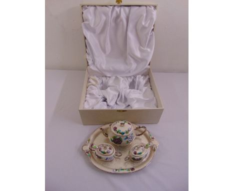 A cased Korean white metal and enamel teaset to include a teapot, two sugar bowls with pull off covers and two sugar spoons