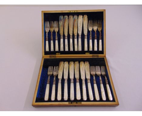 A cased set of twelve fish eaters with Mother of Pearl handles and silver ferules (1 fork missing)