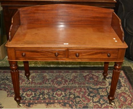 An early 19th century mahogany writing desk, three quarter gallery, two short drawers turned handles to frieze, reeded legs, 