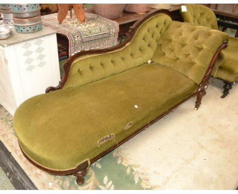 A Victorian mahogany chaise, shaped and padded back, button upholstered scrolling arm, fluted tapering legs, ceramic casters,