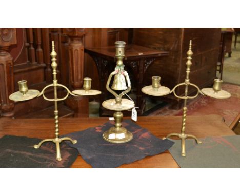 A pair of late 19th Century brass height adjustable two branch table candlesticks, shaped sconces, circular drip pans, tripod